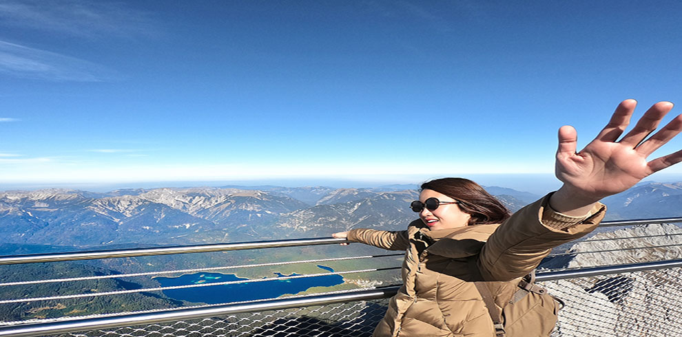 Young Asian Girl Traveller Enjoy On The Bluesky On Peak Mountain